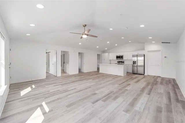 a view of kitchen with kitchen island and stainless steel appliances