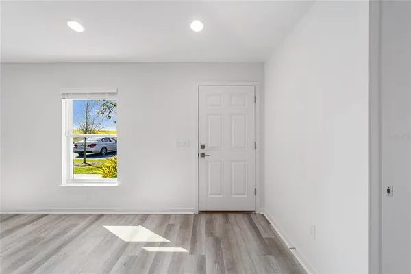 an empty room with painting and windows