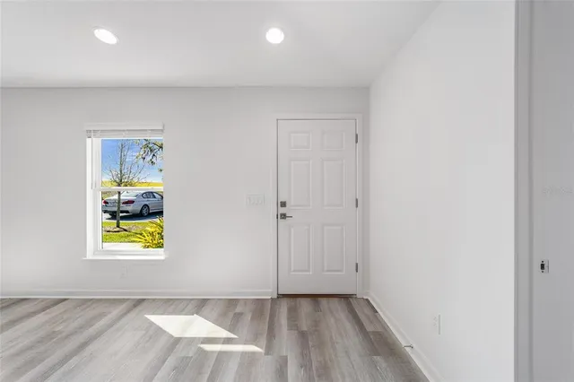 an empty room with painting and windows