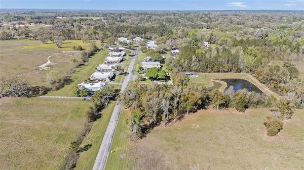 an aerial view of house with yard