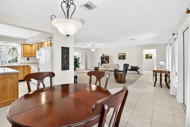 a view of a dining room with furniture and a chandelier