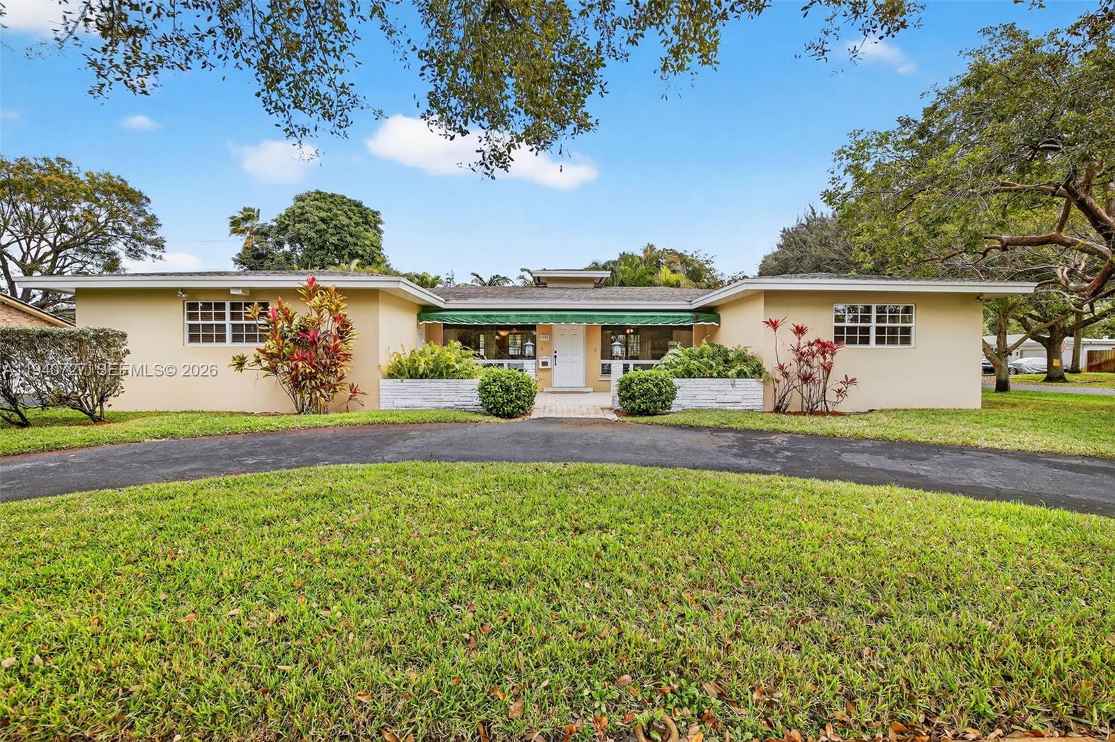 280 Southwest 63rd Avenue Plantation, FL 33317 - Photo 2 of 53 a front view of a house with a yard