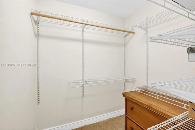 a bedroom with two beds and a large window