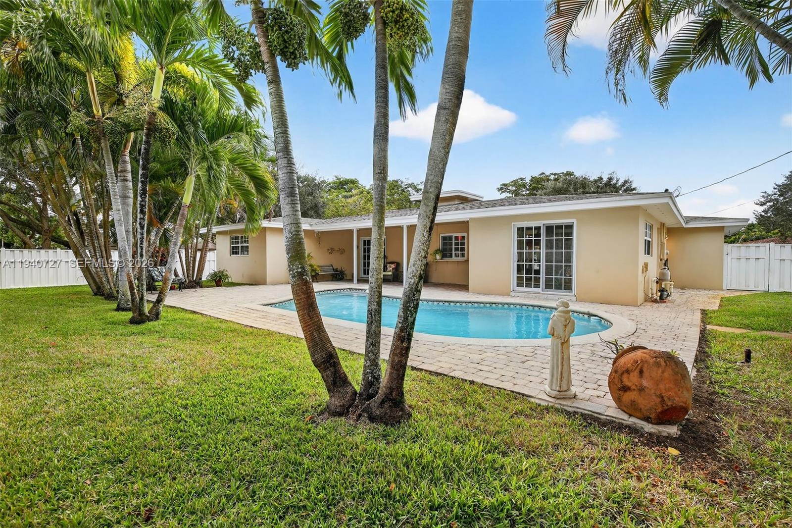280 Southwest 63rd Avenue Plantation, FL 33317 - Photo 40 of 53 a view of a backyard with table and chairs potted plants and palm tree