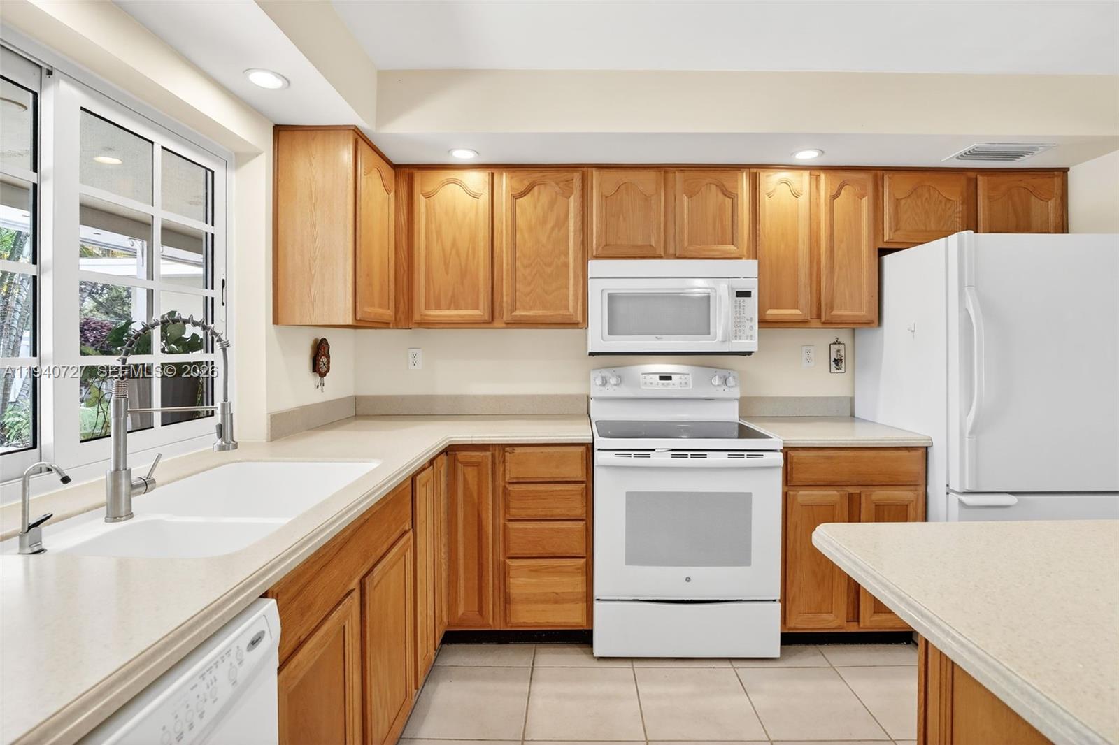 280 Southwest 63rd Avenue Plantation, FL 33317 - Photo 7 of 53 a kitchen with a stove top oven sink and a refrigerator