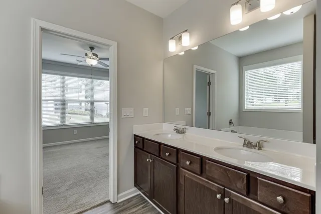 a bathroom with a granite countertop sink mirror and double