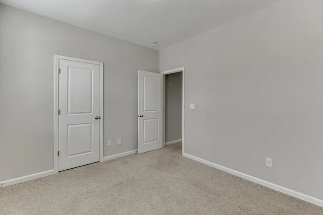 a view of an empty room and closet area