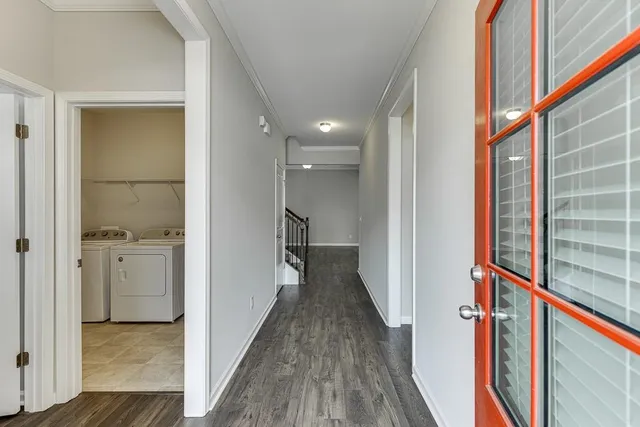 a view of hallway with wooden floor and staircase