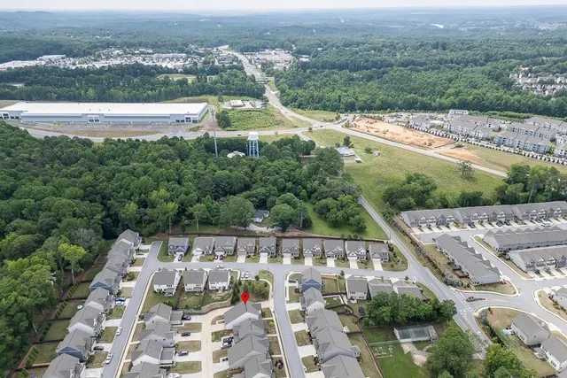 an aerial view of a house with a yard