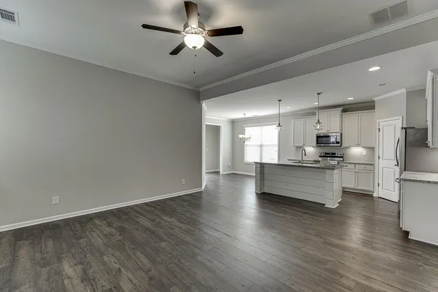 a view of kitchen with refrigerator microwave and stove