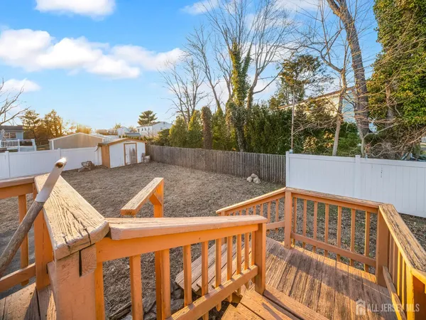 a view of a roof deck with couches and wooden floor