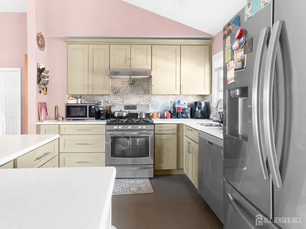 a kitchen with a sink stove and refrigerator