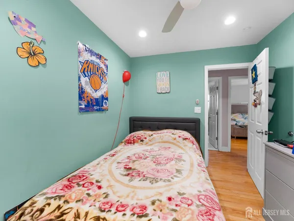 a bedroom with a bed and a painting on the wall