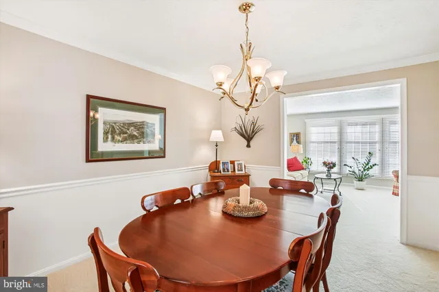 a view of a dining room with furniture wooden floor and chandelier