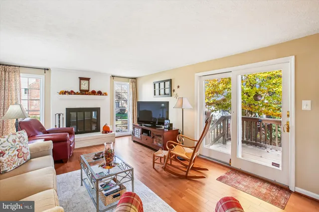 a living room with furniture a large window and a fireplace