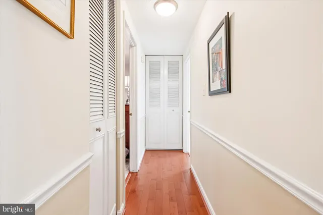 a view of a hallway with wooden floor