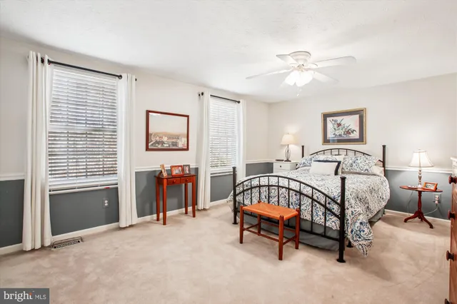 a spacious bedroom with a bed and a chandelier