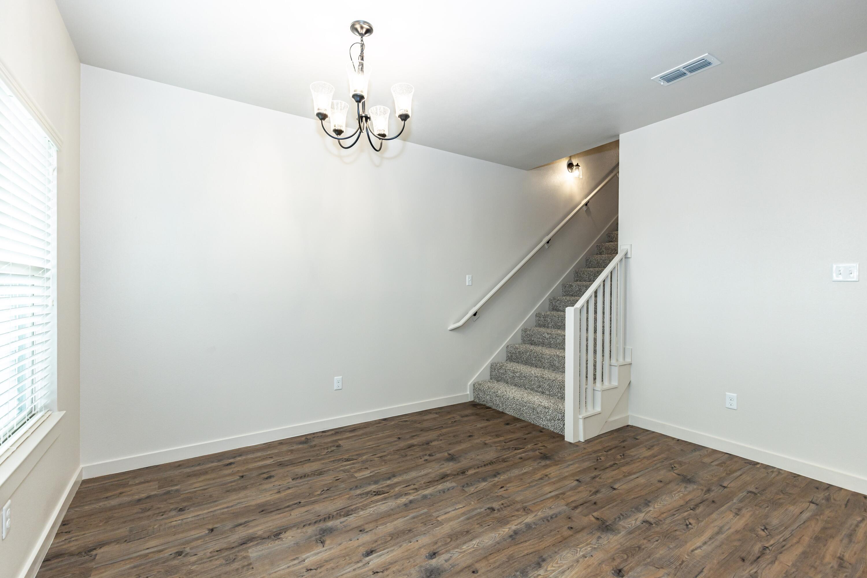2529 138th Street Lubbock, TX 79423 - Photo 11 of 24 a view of a room with wooden floor and staircase
