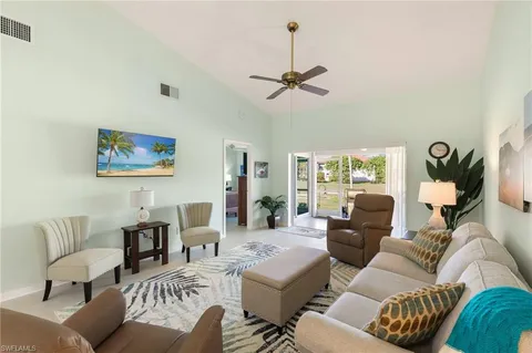 a living room with furniture ceiling fan and a rug