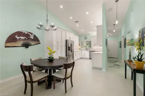 a dining room with furniture and window