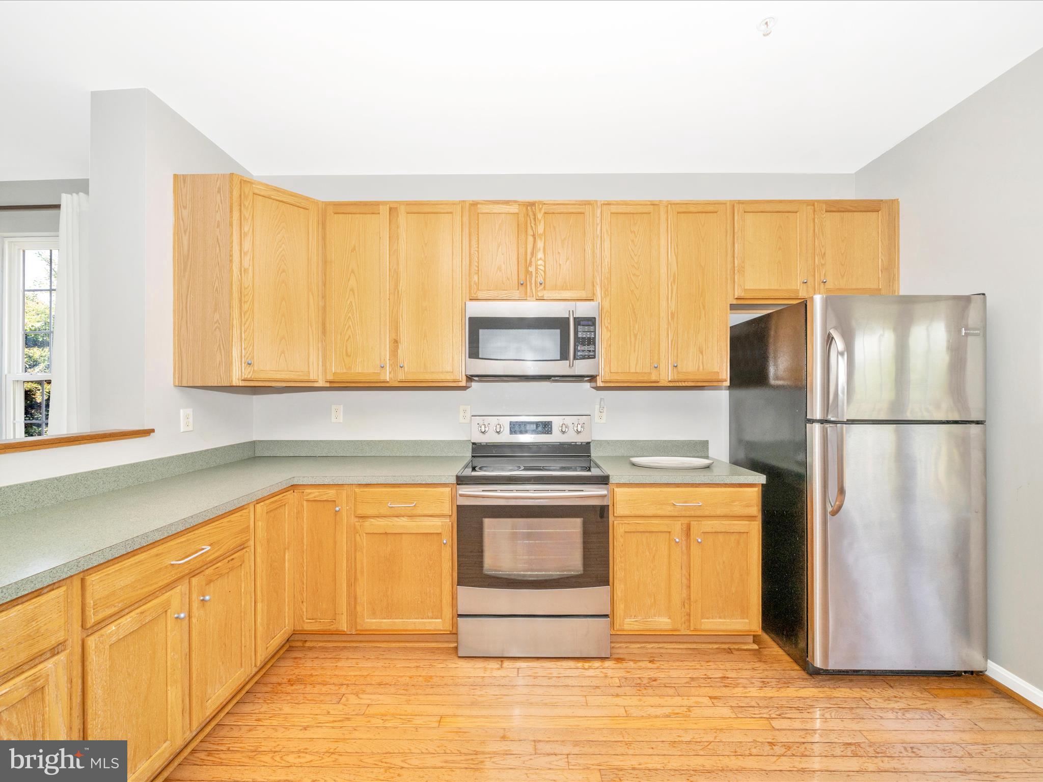 514 Ellison Court Frederick, MD 21703 - Photo 16 of 53 a kitchen with stainless steel appliances granite countertop a refrigerator a stove and a sink with cabinets