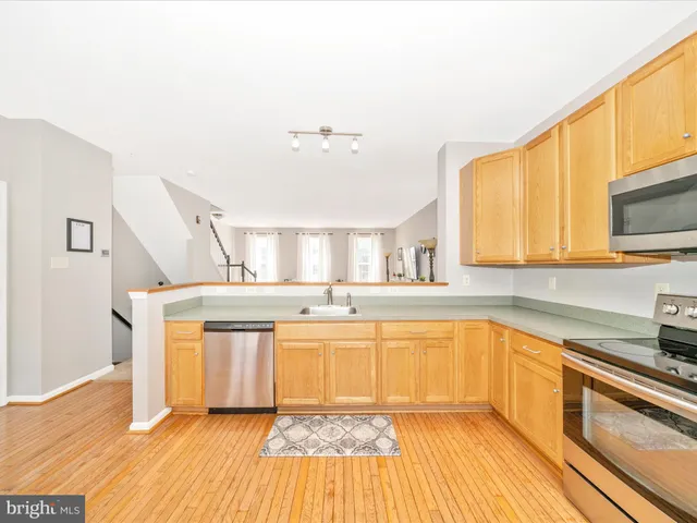 a kitchen with stainless steel appliances a stove sink and microwave
