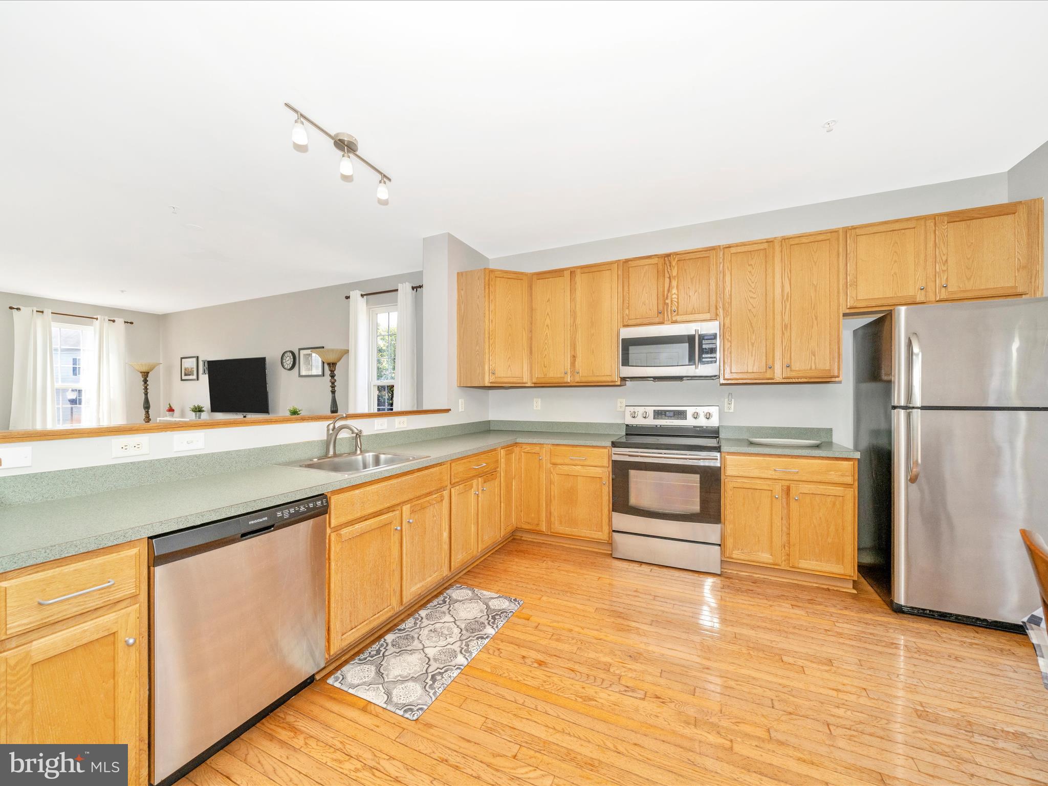 514 Ellison Court Frederick, MD 21703 - Photo 19 of 53 a kitchen with granite countertop a refrigerator stove top oven and sink