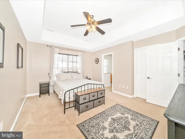 a bathroom with a tub sink vanity and mirror