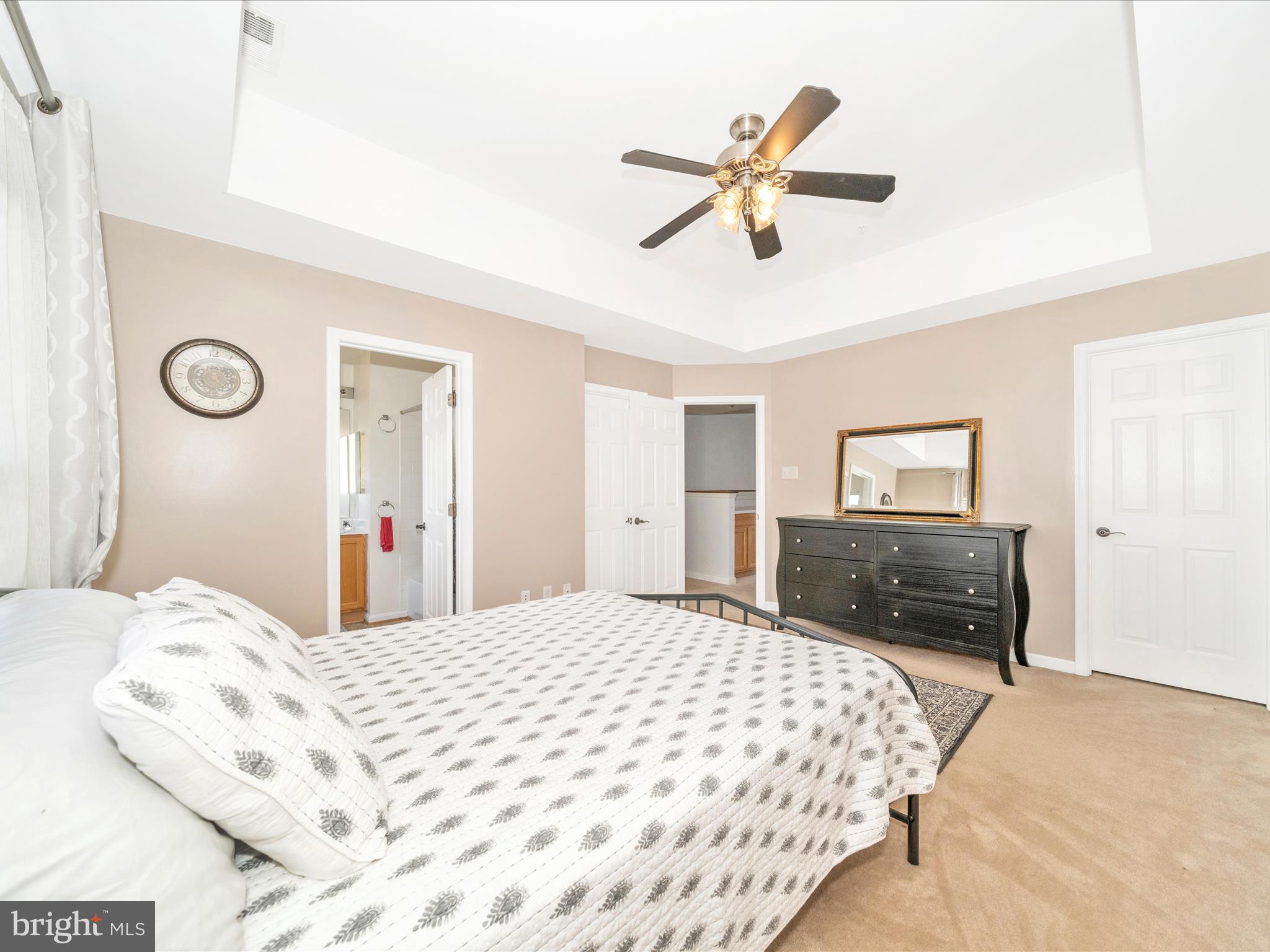 514 Ellison Court Frederick, MD 21703 - Photo 31 of 53 a bedroom with a large bed and a chandelier