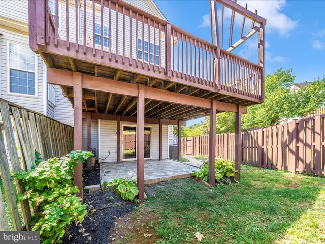 a view of a house with wooden fence
