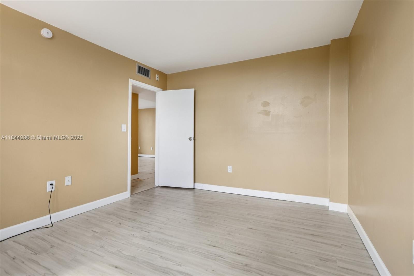 14170 Southwest 84th Street, Unit 501F Miami, FL 33183 - Photo 12 of 26 a view of an empty room with wooden floor