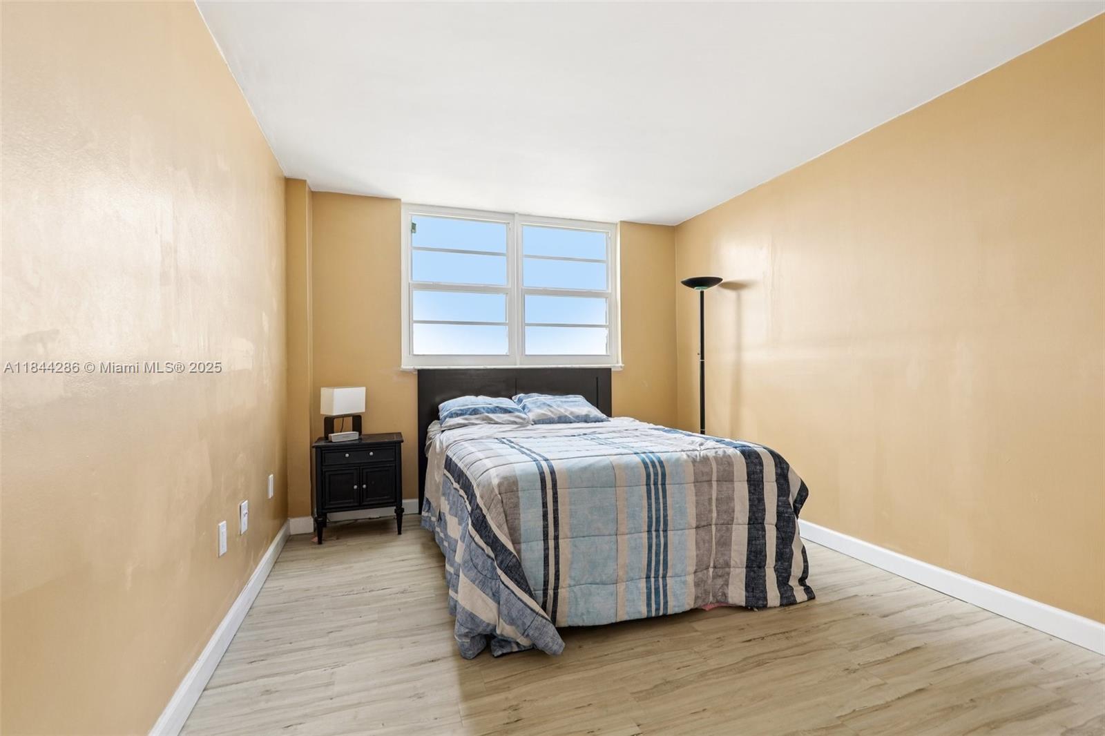 14170 Southwest 84th Street, Unit 501F Miami, FL 33183 - Photo 7 of 26 a bedroom with a bed and wooden floor