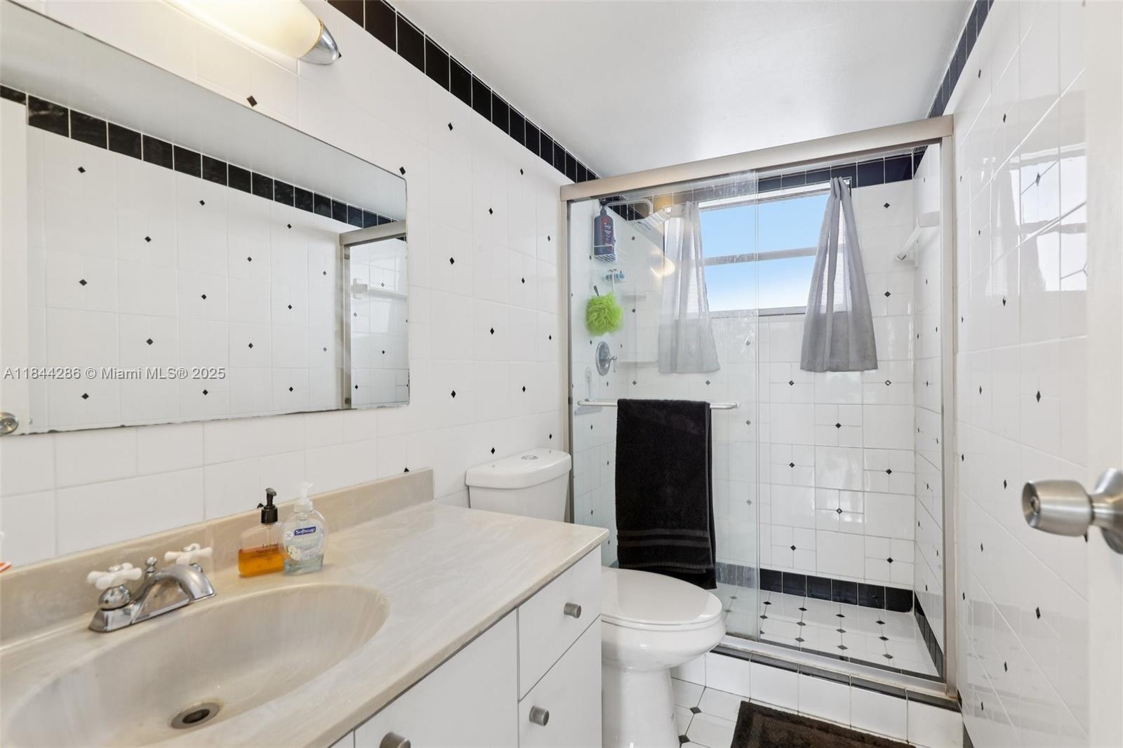 14170 Southwest 84th Street, Unit 501F Miami, FL 33183 - Photo 9 of 26 a bathroom with a sink toilet and shower