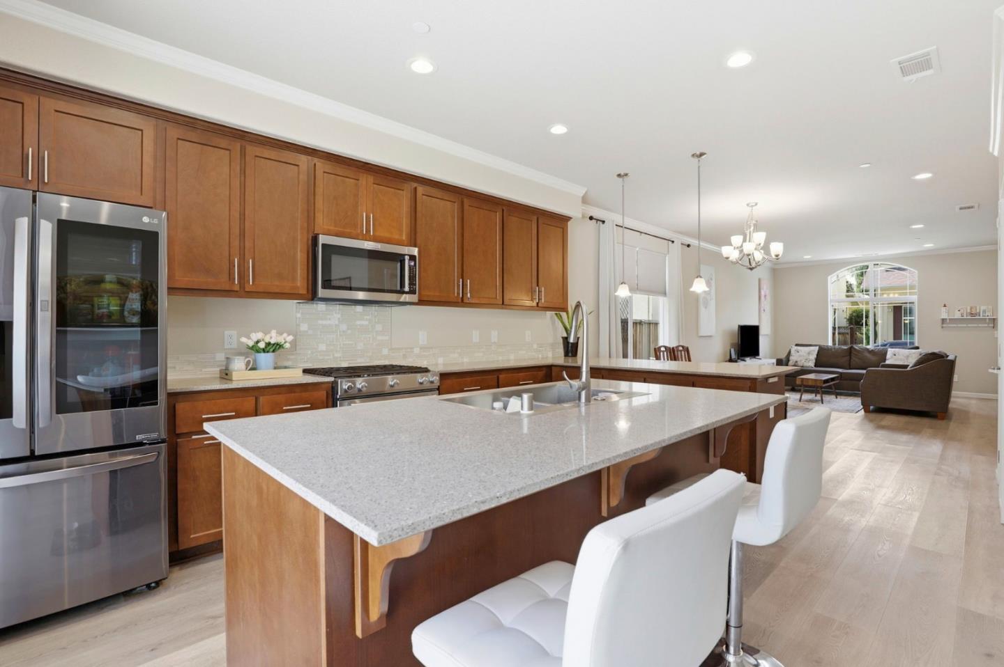 187 Springtime Circle Hollister, CA 95023 - Photo 4 of 19 a kitchen with counter and chairs in it
