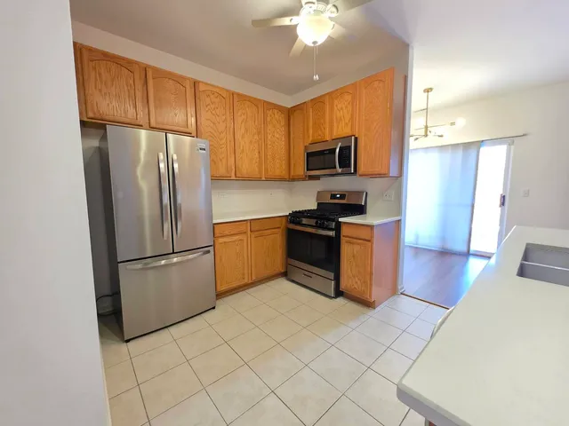 wooden floor in an empty room with a kitchen