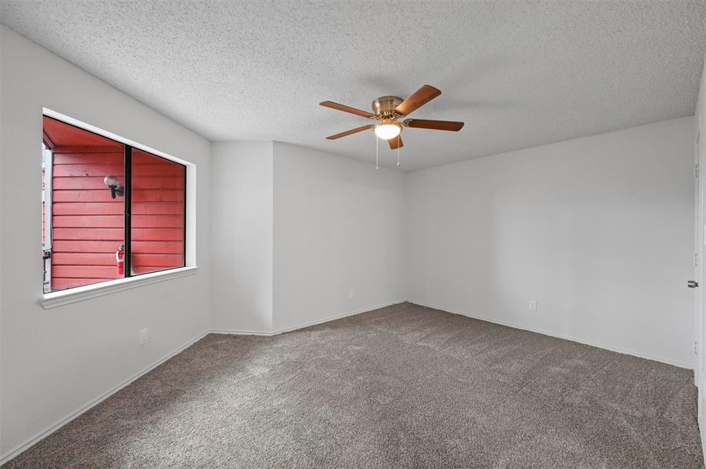 9825 Walnut Street, Unit 206 Dallas, TX 75243 - Photo 16 of 33 an empty room with windows and ceiling fan