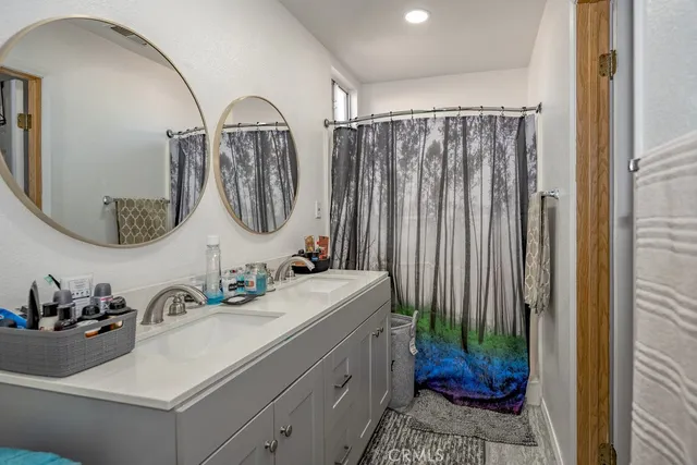 a bathroom with a double vanity sink and a mirror