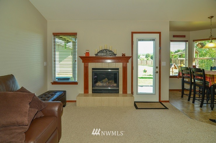 18110 Joseph Drive Southwest Rochester, WA 98579 - Photo 12 of 25 a living room with furniture and a fireplace