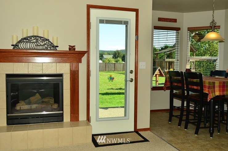 18110 Joseph Drive Southwest Rochester, WA 98579 - Photo 13 of 25 a living room with a fireplace and a window