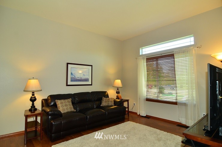 18110 Joseph Drive Southwest Rochester, WA 98579 - Photo 4 of 25 a living room with furniture and a flat screen tv