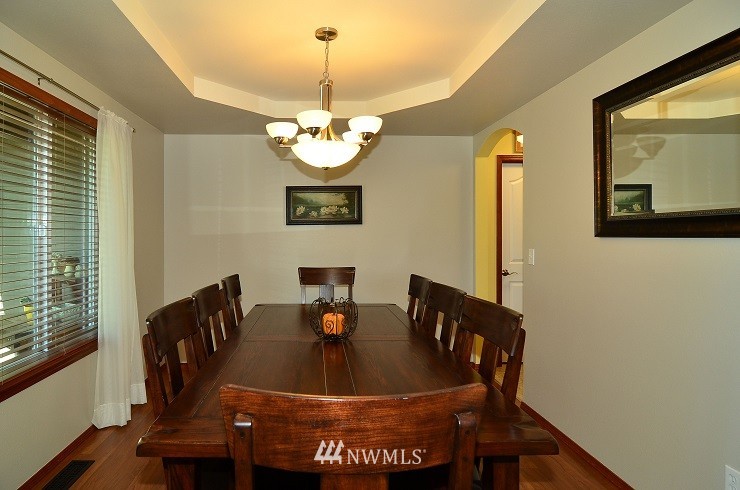 18110 Joseph Drive Southwest Rochester, WA 98579 - Photo 5 of 25 a view of a dining room with furniture wooden floor and chandelier