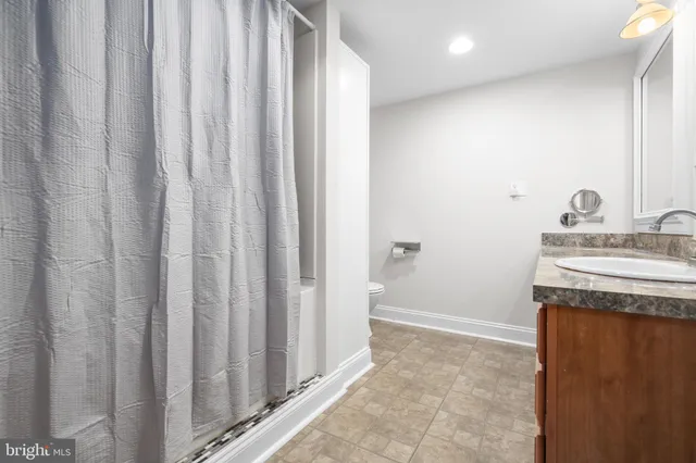 a bathroom with a sink a vanity and a mirror