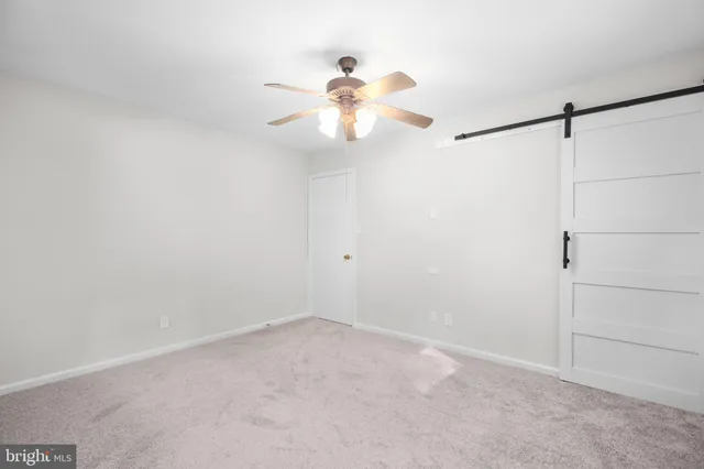 a view of an empty room and a fan