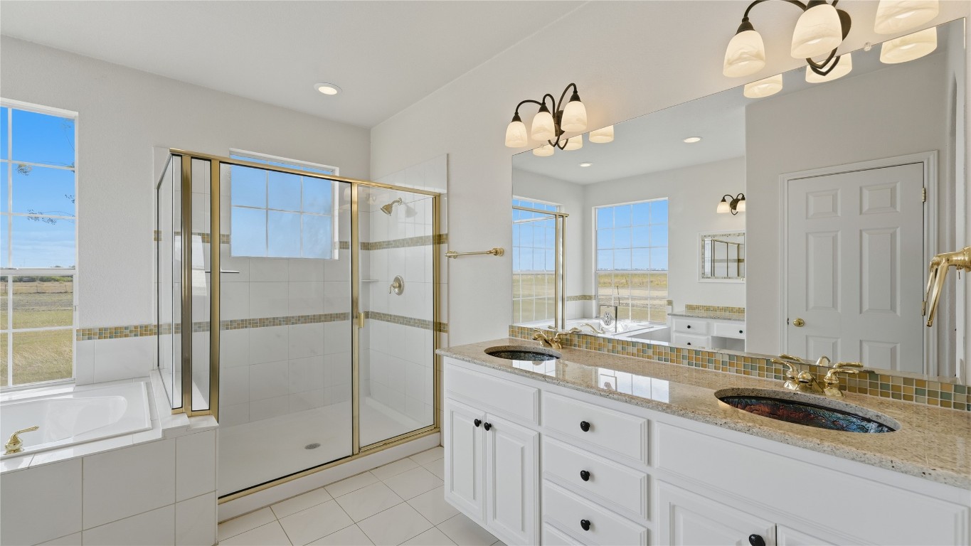 15620 Harry Lind Road Manor, TX 78653 - Photo 19 of 40 a bathroom with a sink a mirror a vanity and a shower