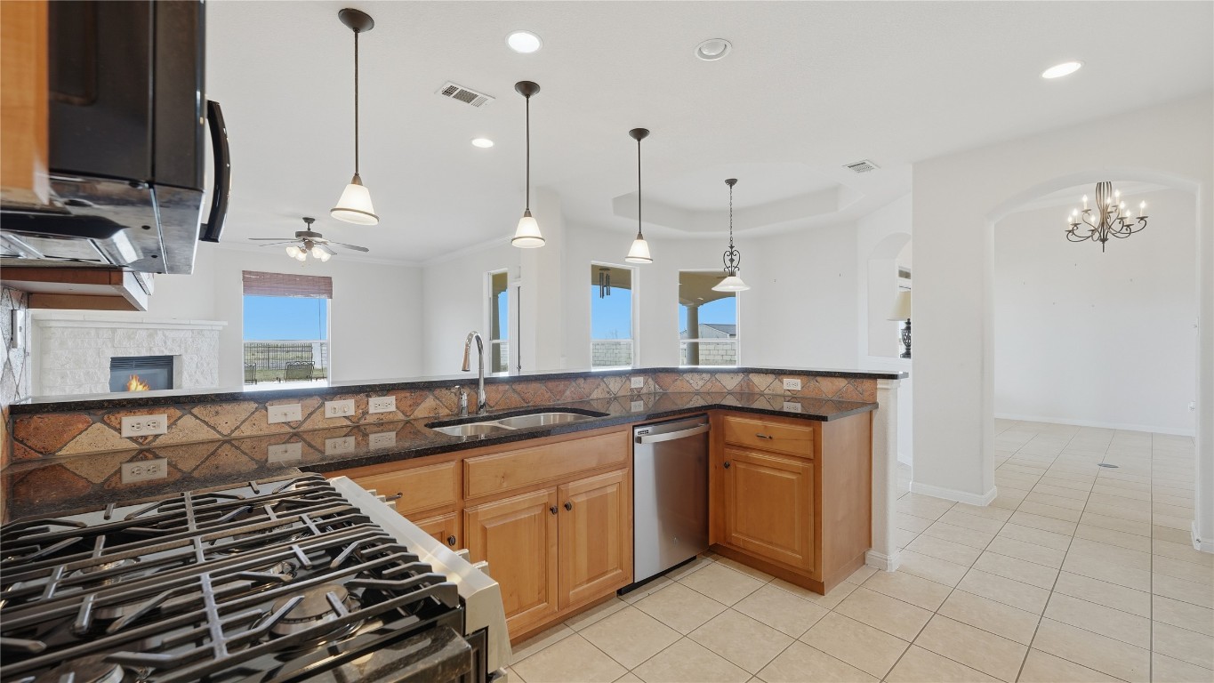 15620 Harry Lind Road Manor, TX 78653 - Photo 24 of 40 a kitchen with a stove and a wooden floor