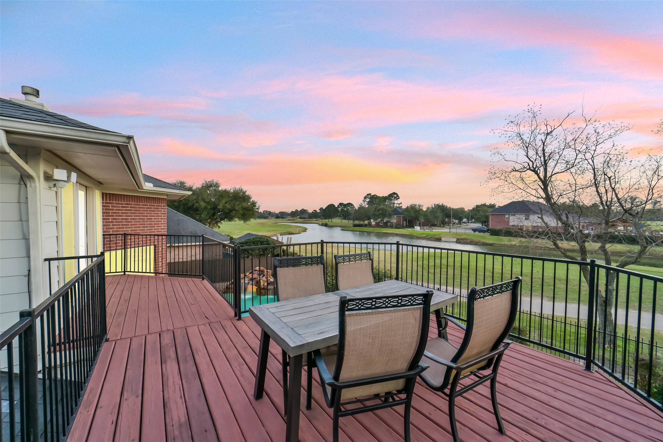 24403 Falcon Point Drive Katy, TX 77494 - Photo 19 of 32 Step out onto the private balcony to enjoy breathtaking, elevated views of the serene lake and the lush greens of the golf course.