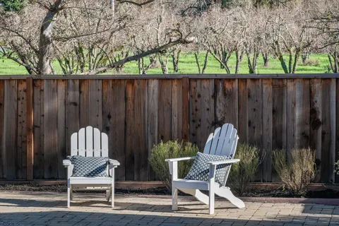 a view of outdoor space with patio furniture and wooden fence