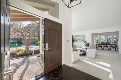a living room with furniture and a floor to ceiling window