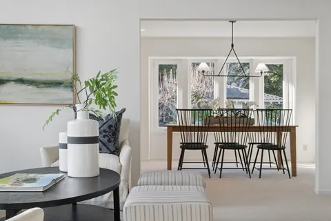 a view of a dining room with furniture and chandelier