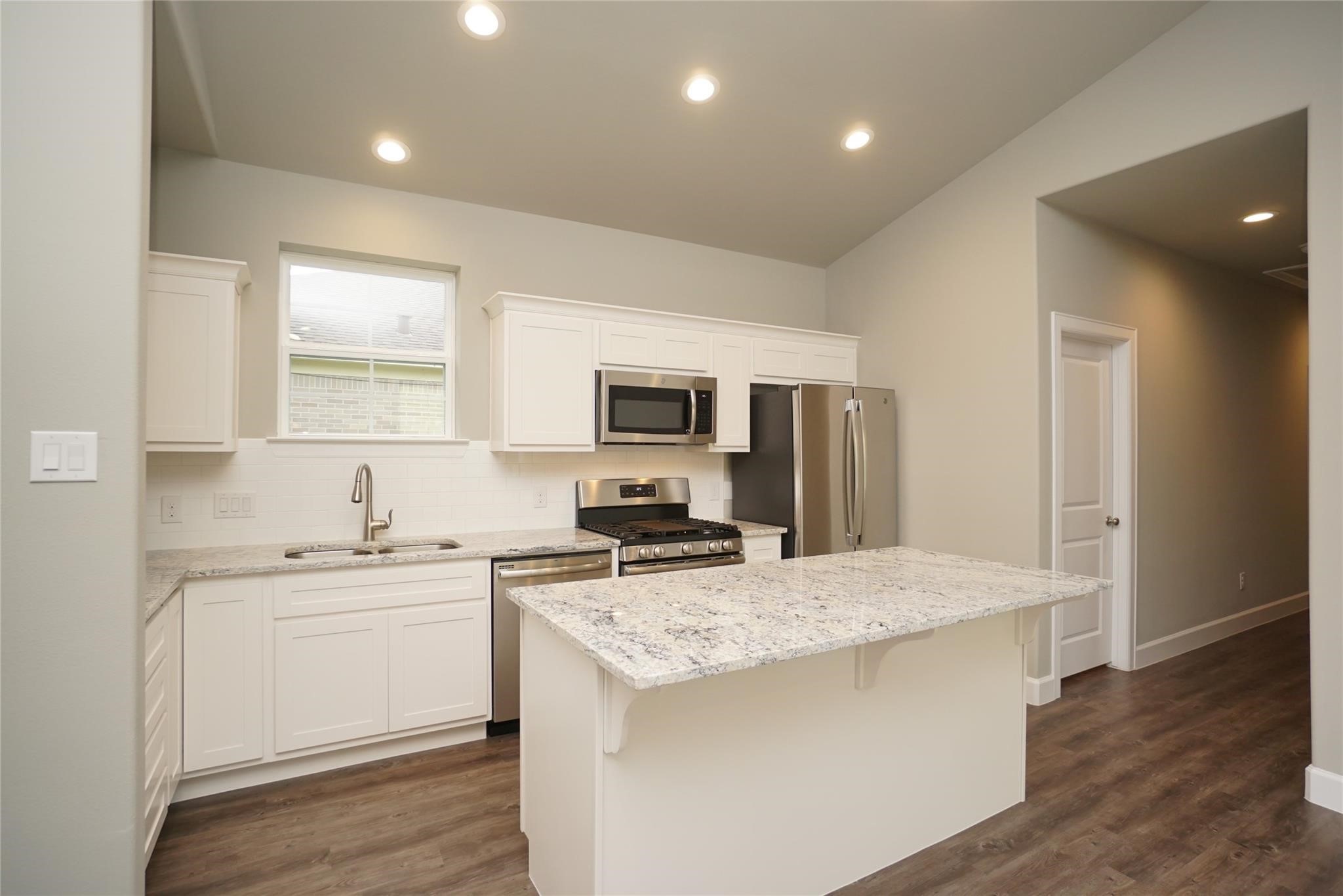 1137 4th Street Rosenberg, TX 77471 - Photo 3 of 16 a kitchen with a sink stove and refrigerator